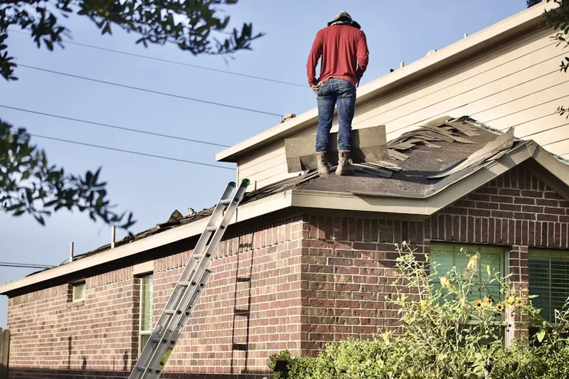 Professional roofer working on a residential roof in Fruitridge Manor